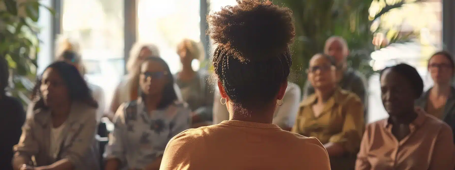 a therapist speaking at a community event, surrounded by engaged local residents and fellow professionals, showcasing collaboration and connection.