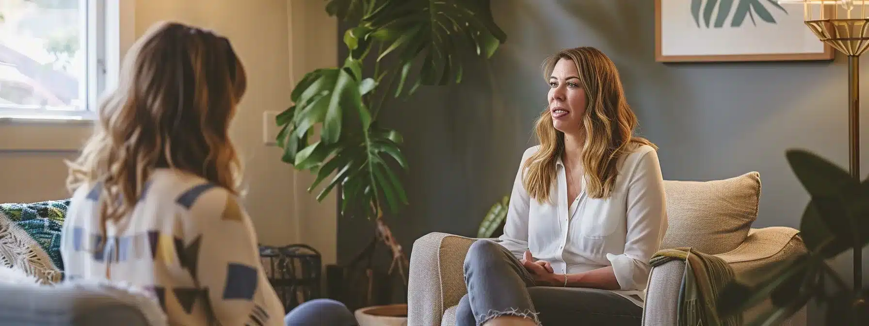 a therapist sitting in their welcoming clinic, surrounded by calming colors and comforting decor, engaging in deep conversation with a client to develop a strong and authentic brand voice.