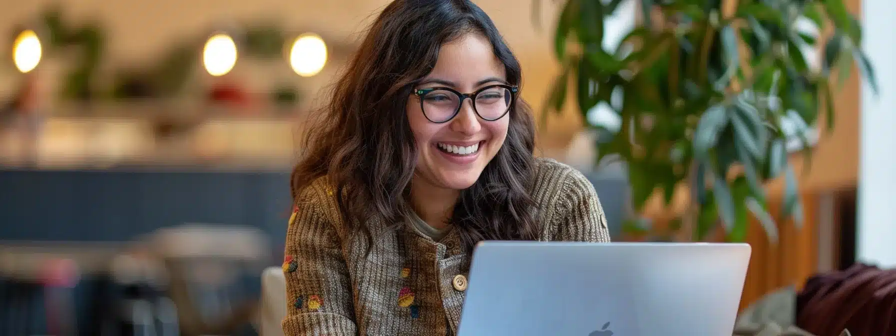 a therapist smiling warmly while reading glowing google reviews on their laptop screen.