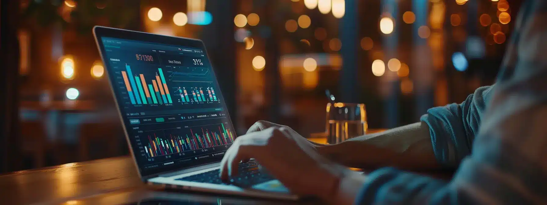 a person analyzing social media data on a laptop while surrounded by charts and graphs illustrating brand performance metrics.