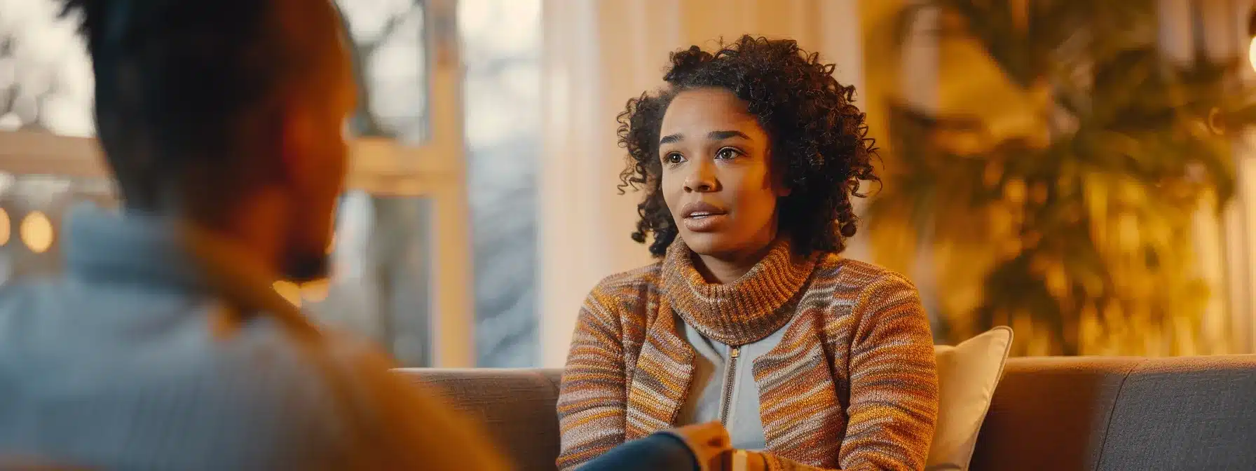 a therapist engaging with clients in a warm, welcoming office setting, listening attentively and showing empathy.