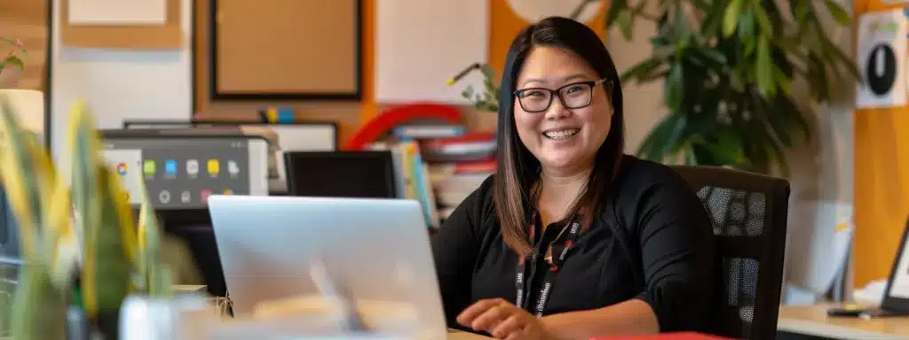 a therapist sitting at a desk, smiling and engaging with a laptop displaying their google my business profile with glowing reviews.