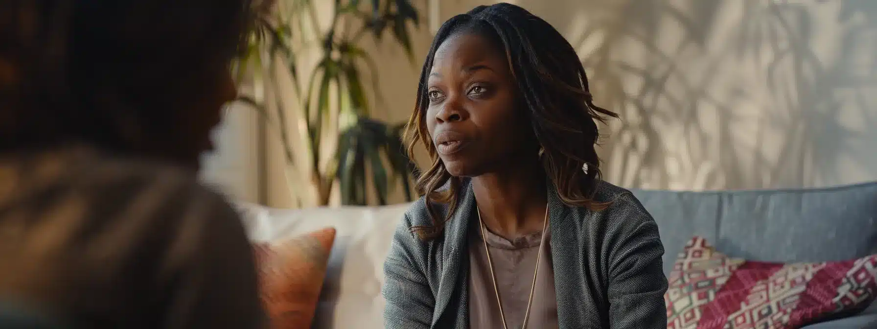 a therapist sitting across from a client, deep in conversation, with a look of understanding and connection in their eyes.